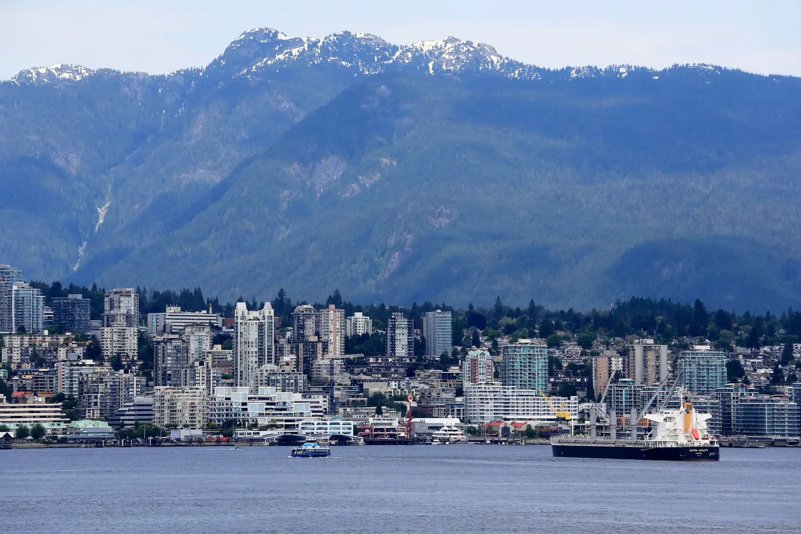 North Vancouver at the foot of forested mountains across Burrard Inlet